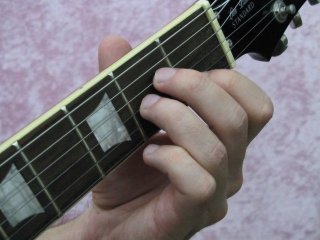 The fretting Hand pressing down the A minor chord