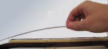 A loose guitar string with slack while restringing