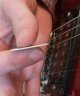 Muting strings by touching them with the side of the palm near the guitar bridge