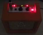 The built-in tuner indicator LEDs in the dark on the Orange Micro Crush amplifier